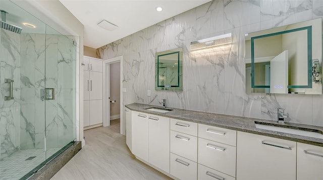 bathroom featuring vanity and an enclosed shower