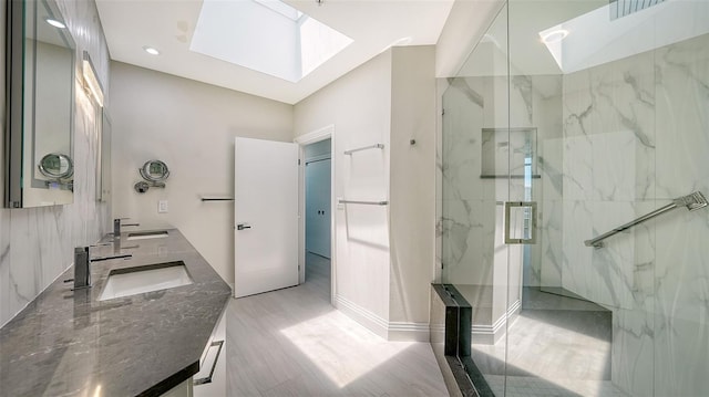 bathroom featuring lofted ceiling with skylight, vanity, hardwood / wood-style flooring, and a tile shower