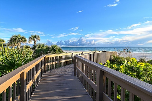 view of property's community featuring a beach view and a water view