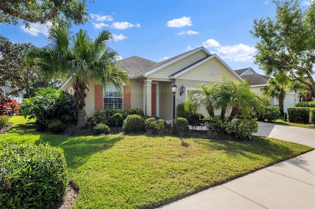 view of front of home featuring a front yard and a garage