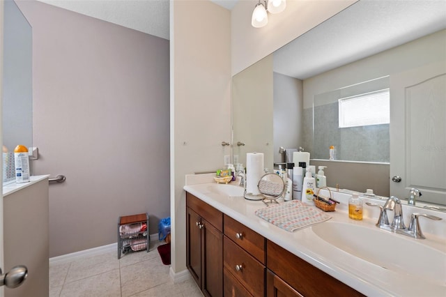 bathroom with tile patterned flooring, vanity, walk in shower, and a textured ceiling