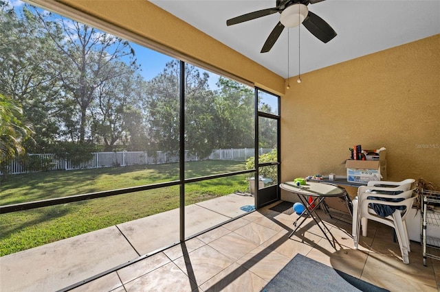 sunroom / solarium featuring ceiling fan