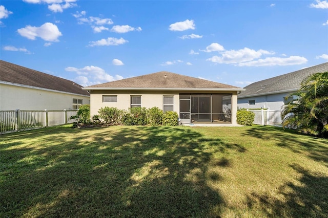 back of house with a sunroom and a yard