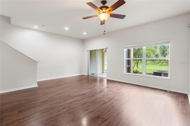 spare room with dark hardwood / wood-style floors and ceiling fan