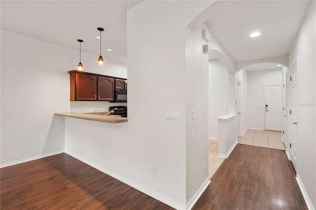 corridor with light hardwood / wood-style flooring