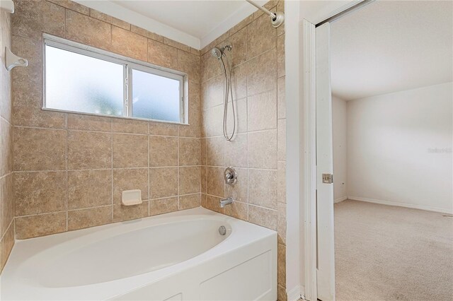 bathroom with tiled shower / bath combo