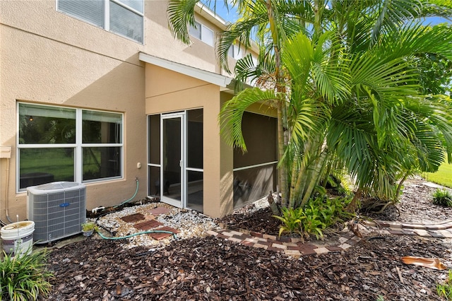 view of side of home featuring a sunroom and central air condition unit