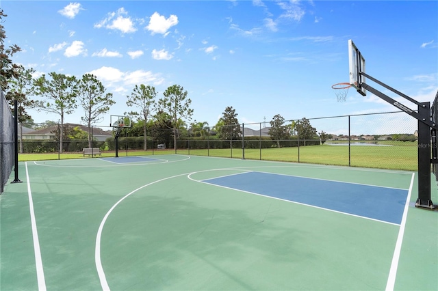 view of sport court featuring a yard