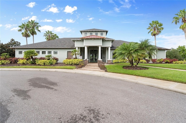 view of front of property featuring a front lawn and french doors