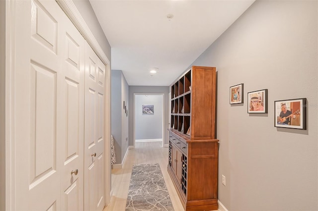 hall with light hardwood / wood-style floors