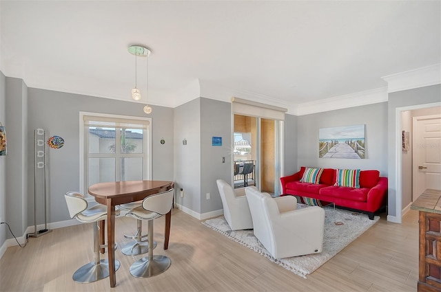 living room with light hardwood / wood-style flooring and ornamental molding