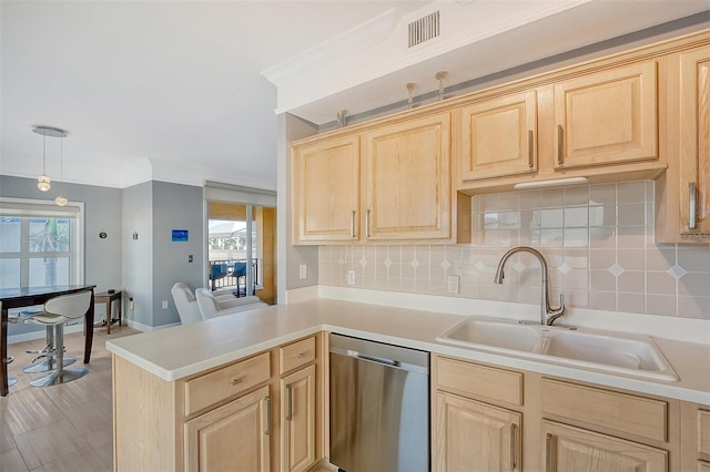 kitchen featuring sink, kitchen peninsula, light brown cabinetry, stainless steel dishwasher, and hanging light fixtures