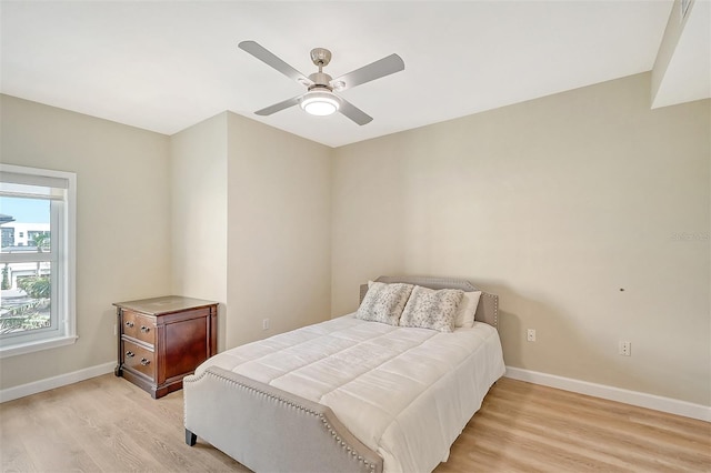 bedroom featuring light hardwood / wood-style floors and ceiling fan