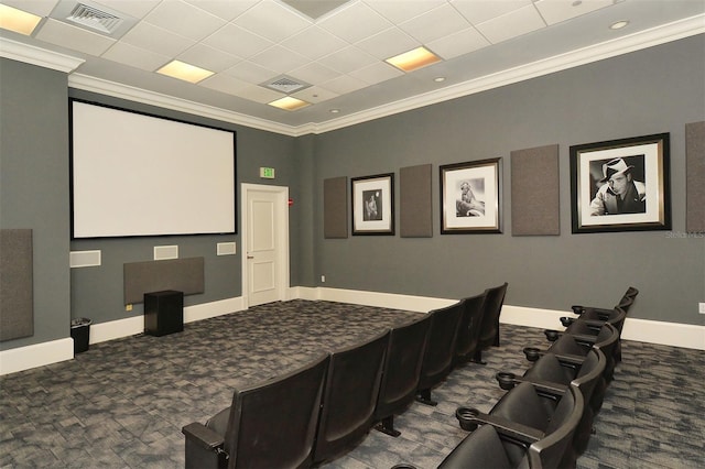 carpeted home theater room featuring a paneled ceiling and crown molding