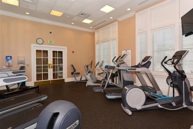 exercise room with a drop ceiling, french doors, and crown molding