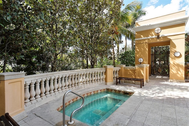 view of pool with an in ground hot tub