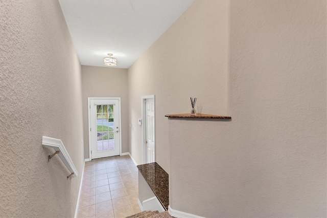 doorway to outside with light tile patterned floors