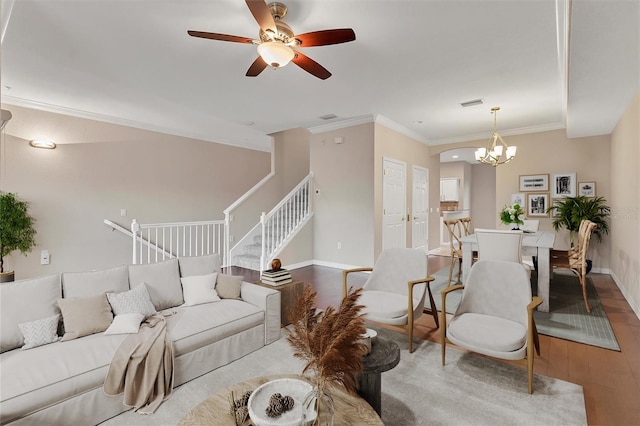 living room with ceiling fan with notable chandelier, crown molding, and light hardwood / wood-style floors