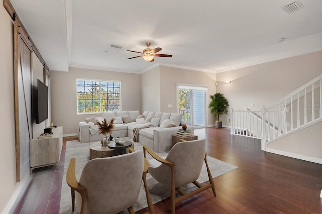 living room featuring ceiling fan, crown molding, and dark wood-type flooring