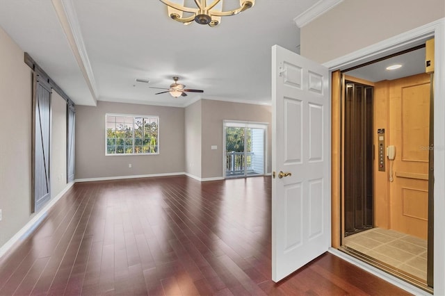 interior space with ceiling fan with notable chandelier, crown molding, dark hardwood / wood-style floors, and a barn door