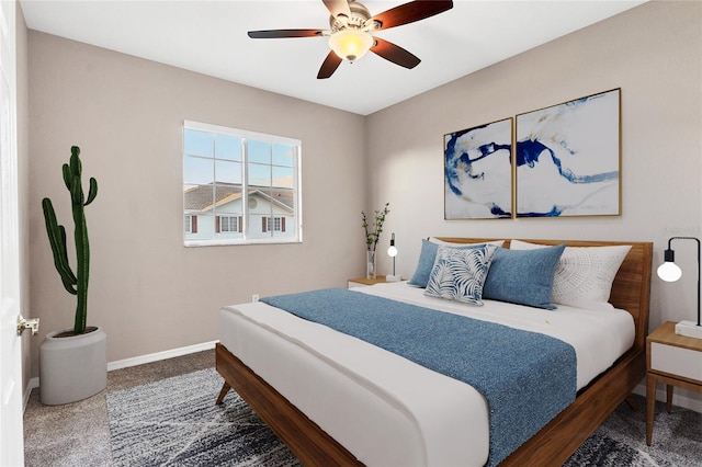 bedroom featuring ceiling fan and dark colored carpet