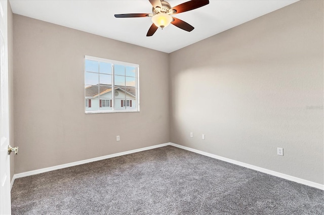 unfurnished room with ceiling fan and carpet