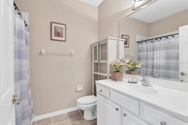 bathroom with vanity, toilet, and tile patterned floors