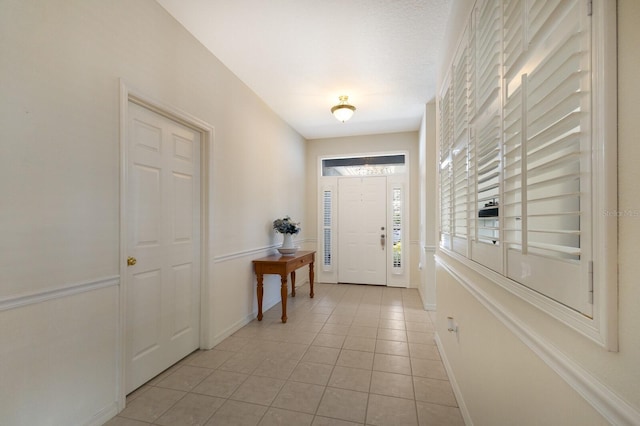 doorway with light tile patterned flooring