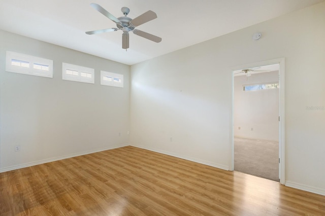 unfurnished room with plenty of natural light, ceiling fan, and light hardwood / wood-style flooring