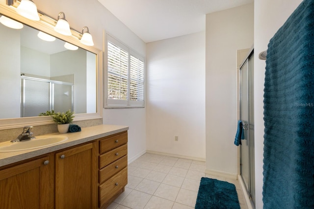 bathroom featuring walk in shower, tile patterned flooring, and vanity