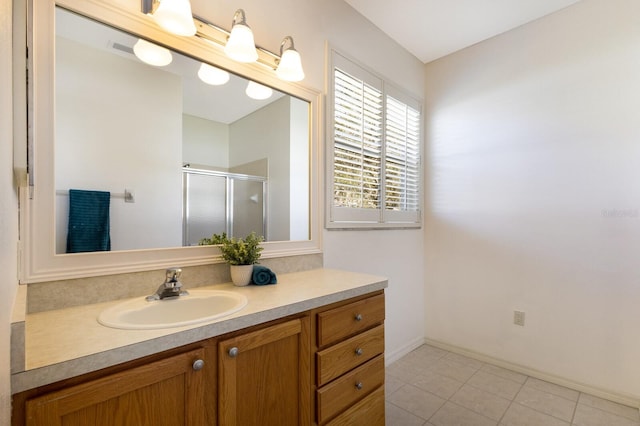 bathroom with vanity, tile patterned floors, and a shower with shower door