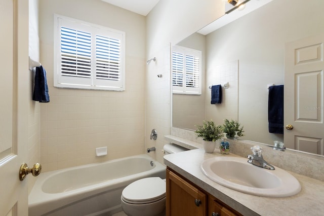 full bathroom with vanity, toilet, and tiled shower / bath