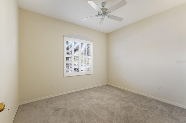 spare room with light colored carpet and ceiling fan