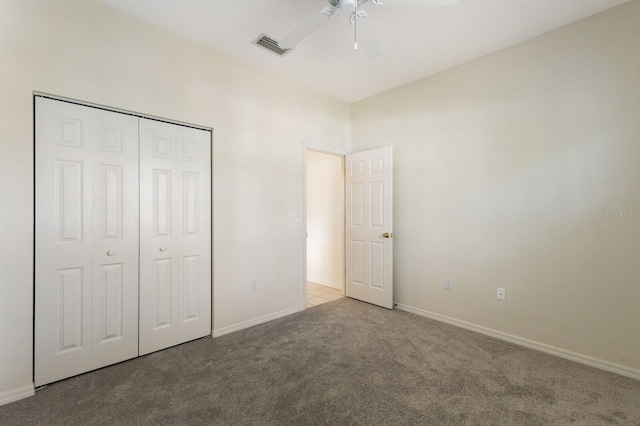 unfurnished bedroom with carpet floors, ceiling fan, and a closet