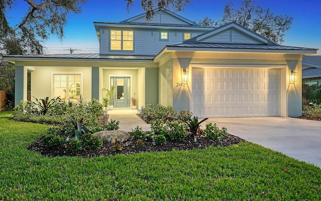 view of front of property with a garage and a front lawn