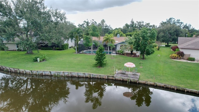 dock area with a water view and a lawn