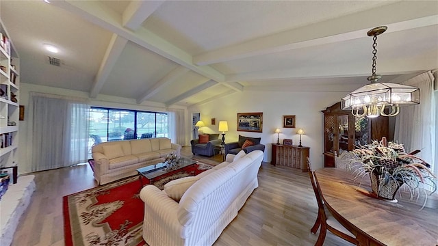 living room with vaulted ceiling with beams, wood-type flooring, and a notable chandelier