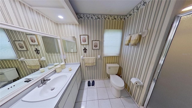 bathroom featuring toilet, vanity, tile patterned floors, and walk in shower