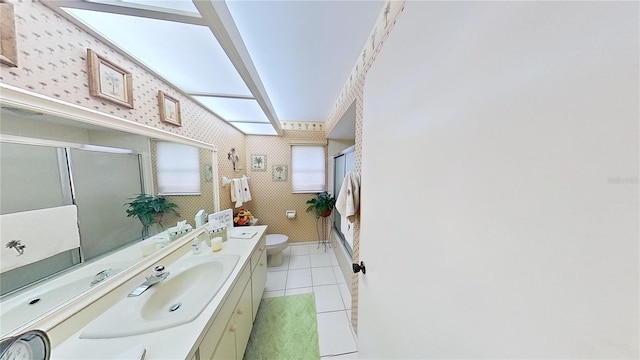 bathroom featuring tile patterned floors, a shower with door, vanity, and toilet