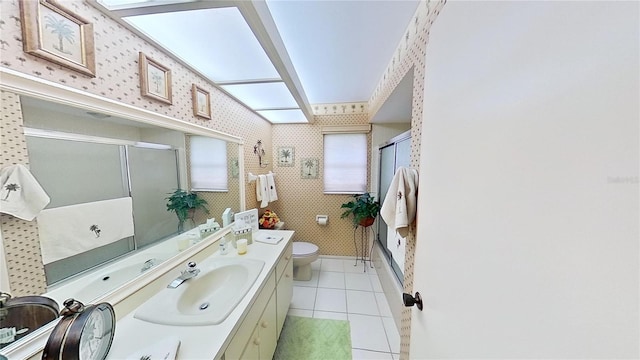 full bathroom with tile patterned flooring, vanity, toilet, and enclosed tub / shower combo