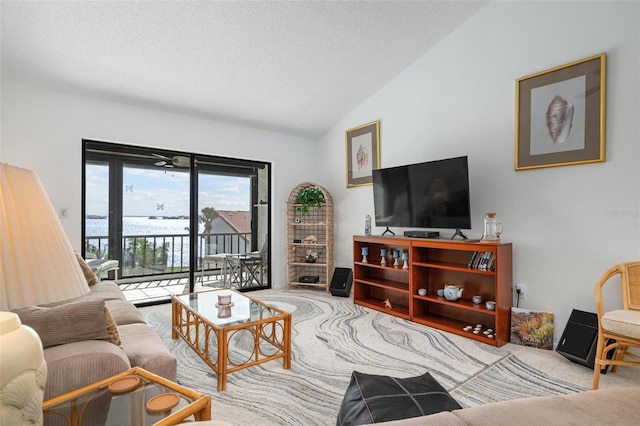 living room featuring vaulted ceiling, light colored carpet, and a textured ceiling