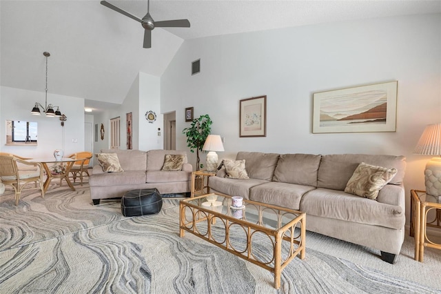 living room featuring ceiling fan with notable chandelier, lofted ceiling, and light colored carpet