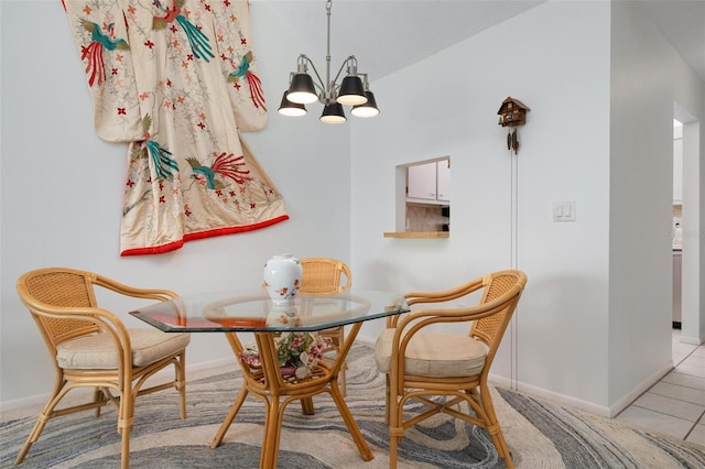 dining room with light tile patterned floors and a chandelier