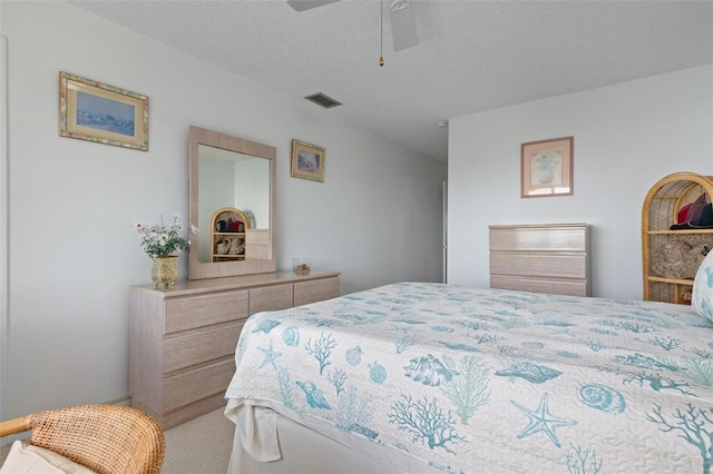 bedroom with a textured ceiling and ceiling fan