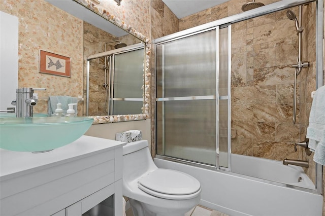 full bathroom with vanity, combined bath / shower with glass door, and toilet