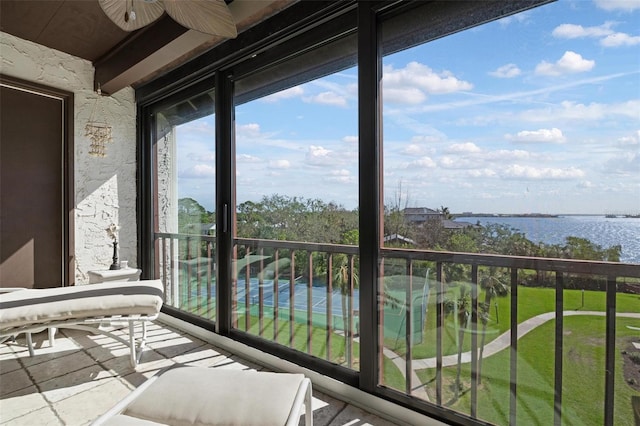 balcony featuring ceiling fan and a water view