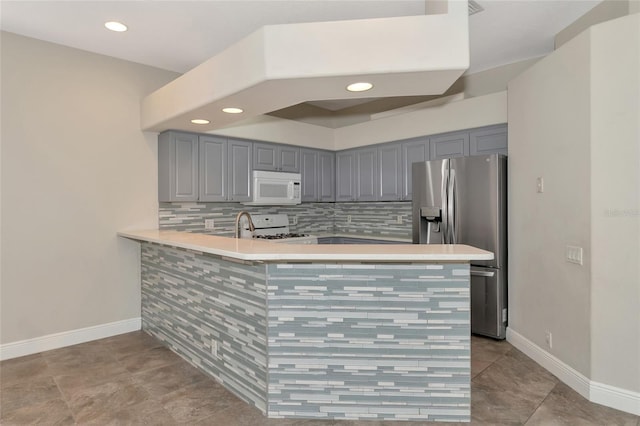 10550 Old Grove Cir, Bradenton, FL 34212 - kitchen with white appliances, gray cabinets, a peninsula, light countertops, and recessed lighting