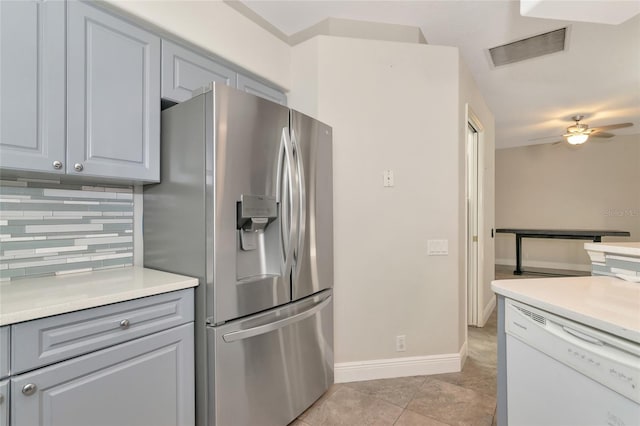 10550 Old Grove Cir, Bradenton, FL 34212 - kitchen featuring stainless steel fridge, white dishwasher, a ceiling fan, decorative backsplash, and light countertops