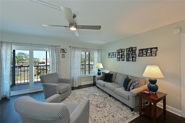 living room featuring ceiling fan and dark wood-type flooring