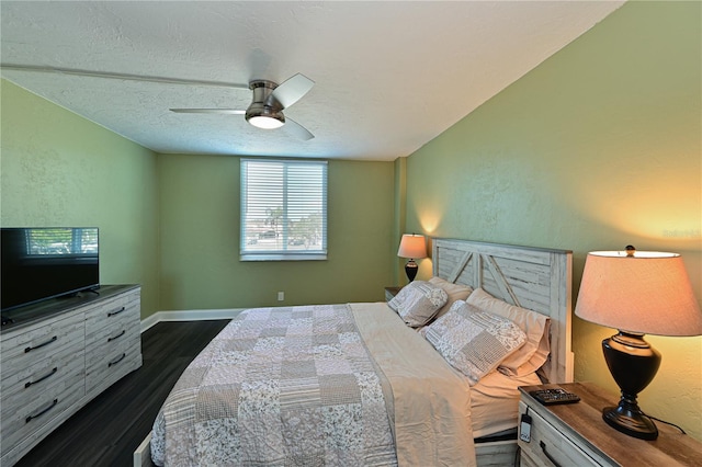 bedroom featuring a textured ceiling, ceiling fan, and dark hardwood / wood-style floors